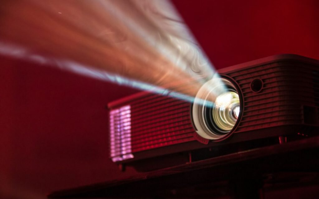 A film projector casting light in a dark room