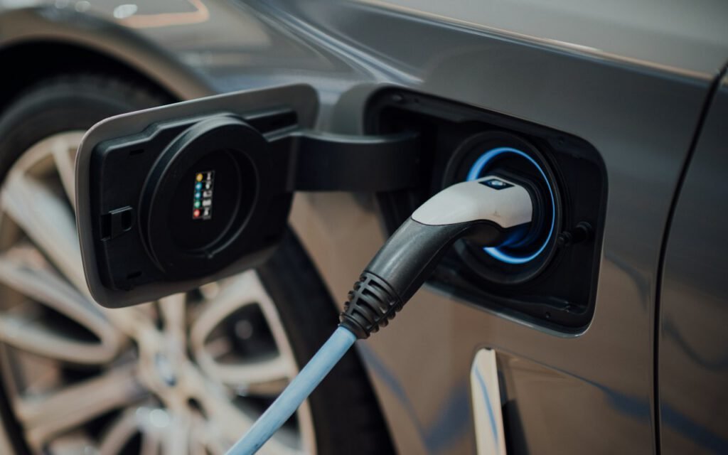An electric vehicle connected to a wall-mounted charging station