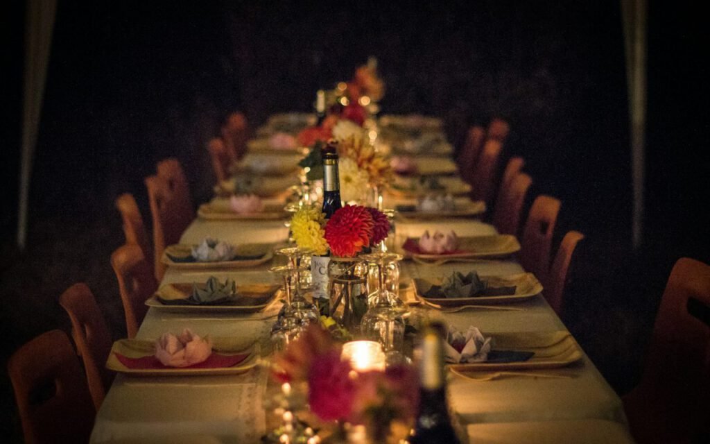 A candlelit dinner table set for a small group
