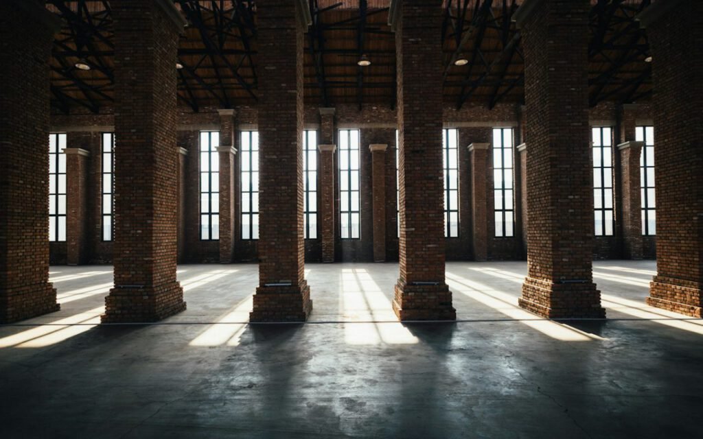 A bright empty event hall with tall windows