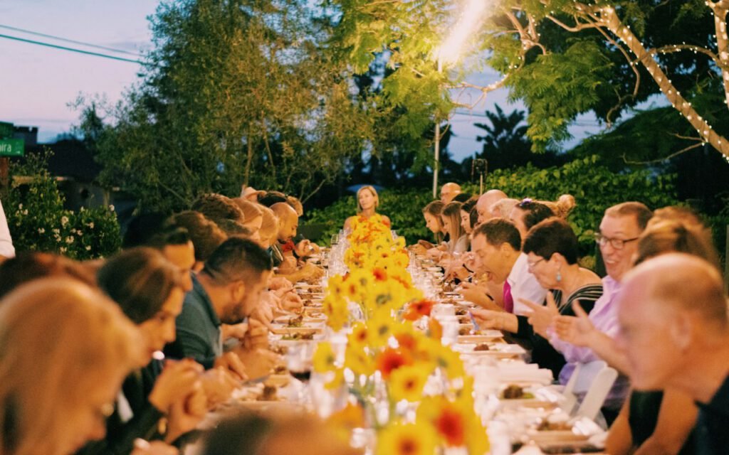 A long dinner table set for a reception with candles