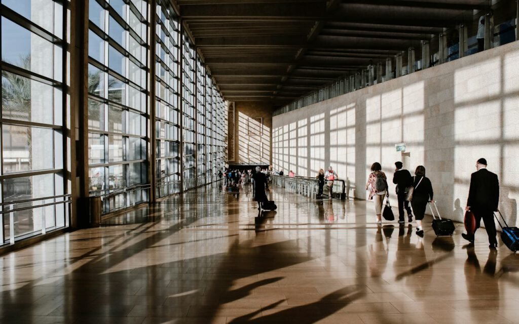 Travelers walking through a bright airport terminal