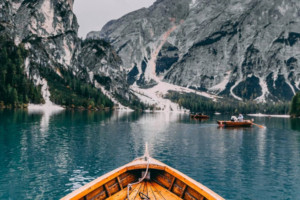 A calm mountain lake surrounded by forest at dawn