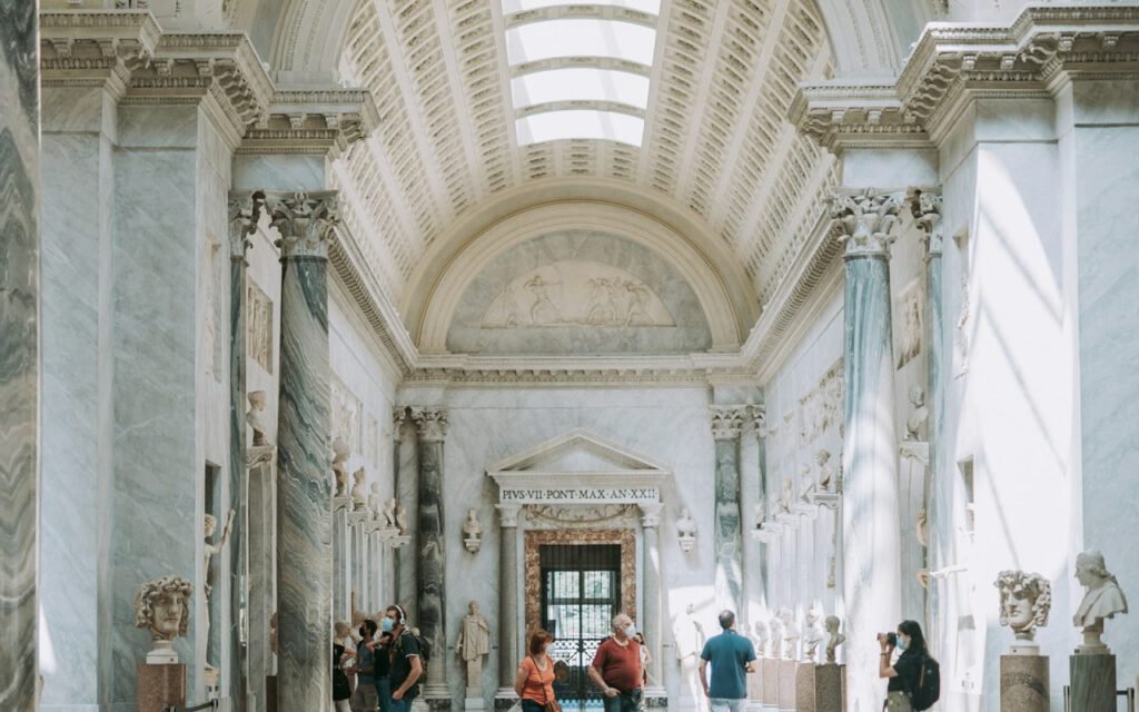 A visitor walking through a bright art gallery