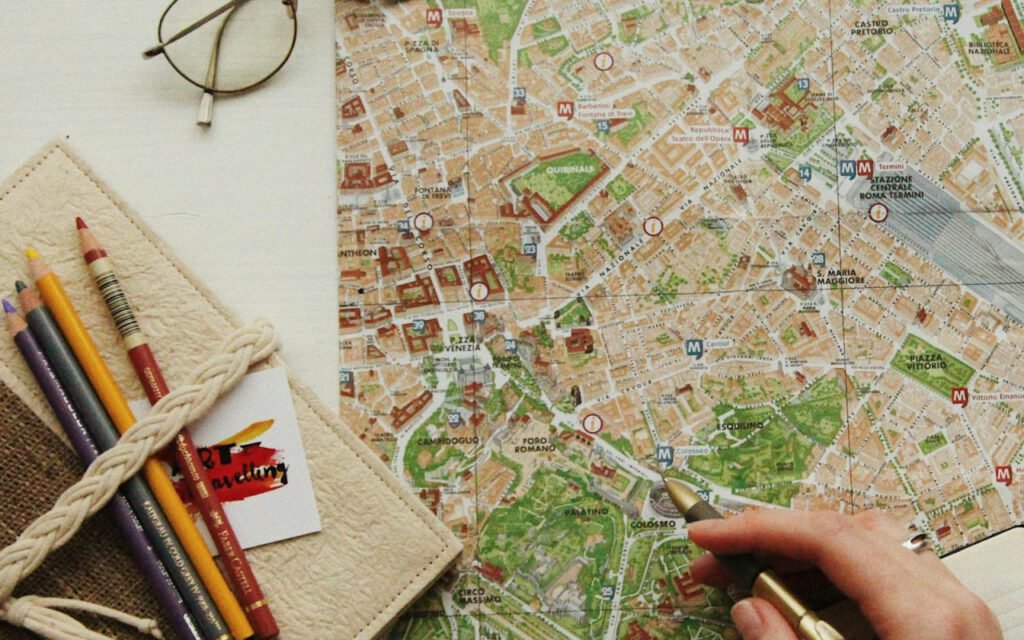 A travel map spread out on a table with trip essentials